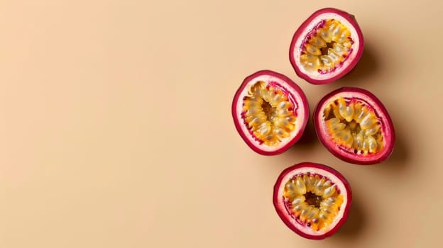 Four sliced passion fruits on a beige background.