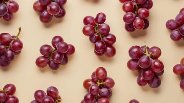 Red grapes on beige background, studio shot. Food and nutrition concept.