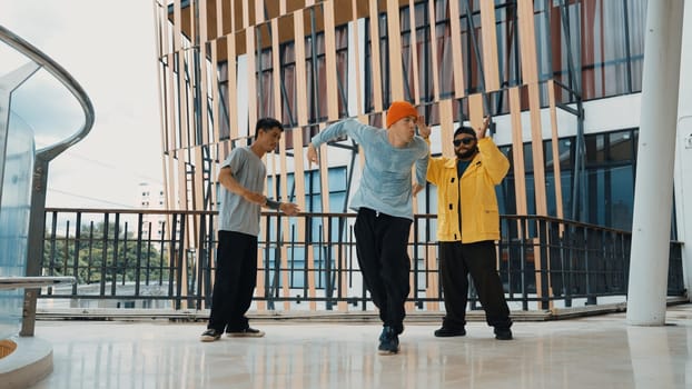 Hip hop team dance break dance while multicultural friend surrounded and clapping hands to cheer or encourage his friend to dance. Active and energetic street dance. Outdoor sport 2024. Endeavor.