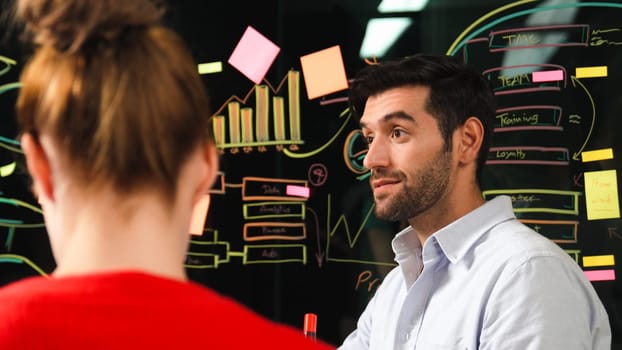 Professional businessman presenting marketing idea or financial plan to smart investor. Executive manager sharing, talking, working together with cooperative colleagues. Business concept. Tracery