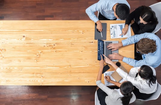 Panorama top view diverse group of business analyst team analyzing financial data report paper on meeting table. Chart and graph dashboard by business intelligence analysis. Meticulous