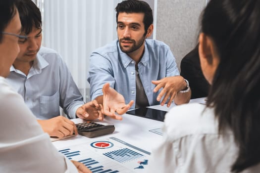 Analyst team utilizing BI Fintech to analyze financial data at table in meeting room. Businesspeople analyzing BI dashboard power on paper for business insight and strategic marketing planning.Prudent