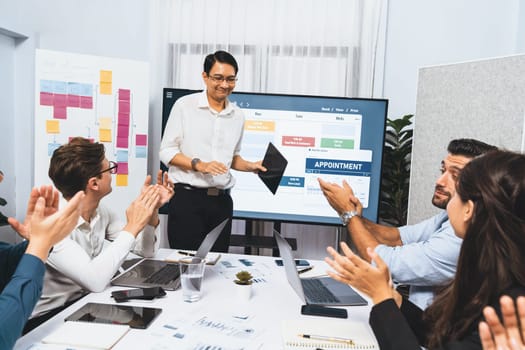 Happy office worker and project manager celebrate in meeting room after successfully achieving business task on time and on schedule. Project management tracking software for business success. Prudent