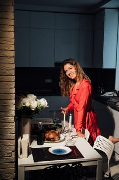 woman in elegant clothes prepares an evening dinner with chicken duck meat