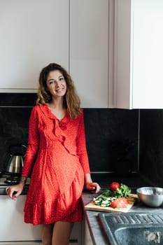 woman in the kitchen prepares food salad healthy food near the sink