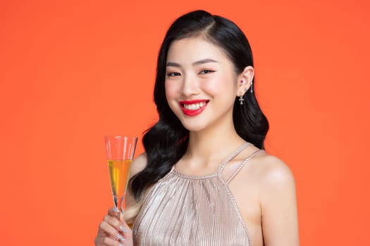 charming cheerful young lady hold sparkling wine enjoy occasion isolated on red color background