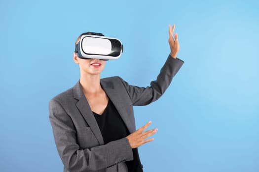 Caucasian business woman excited to explore visual reality world while standing and pointing at data. Skilled project manager wearing VR goggle and suit. Technology innovation concept. Contraption.