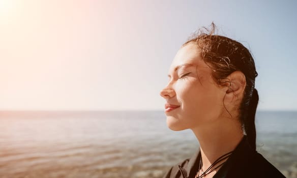 Woman travel sea. Young Happy woman posing on a beach near the sea on background of volcanic rocks, like in Iceland, sharing travel adventure journey