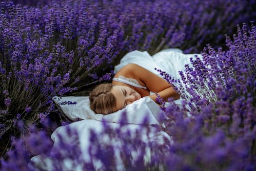 A middle-aged woman lies in a lavender field and enjoys aromatherapy. Aromatherapy concept, lavender oil, photo session in lavender.