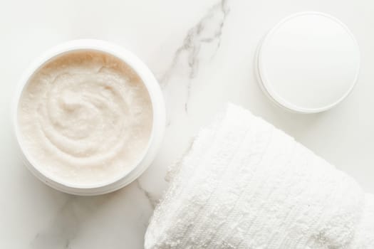 Scrub and exfoliating cream products on a marble, flatlay - skincare and body care, luxury spa and clean cosmetic concept. Health and beauty of your skin