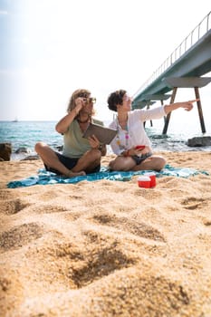 Young couple on vacation on the beach, looking for information about hotels, shopping centers and transport guides. lifestyle and travel concept.