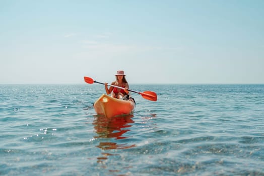 Kayak sea woman. Happy attractive woman with long hair in red swimsuit, swimming on kayak. Summer holiday vacation and travel concept