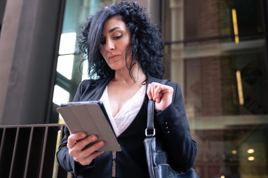 portrait of a smiling middle-aged business woman with digital tablet in smiling hands