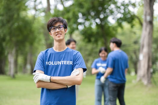 A team of volunteers working together to pick up trash in a park, showcasing community service and environmental conservation efforts.