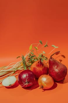 Fresh organic vegetables on vibrant orange surface healthy eating and nutrition concept