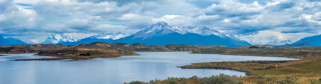 Serene lake with snowy mountains.