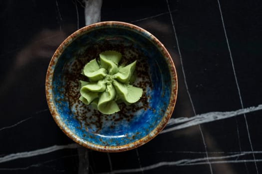 Top view of a ceramic bowl of Wasabi, typical dressing in East Asia.