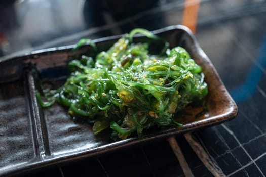 Nice view of a bowl of Wakame seaweed salad, typical dish in East Asia.