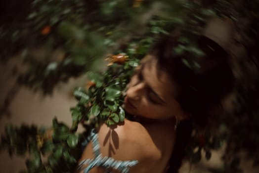 A woman surrounded by leaves and berries, with a dreamy focus effect, creating an airy, artistic and ethereal vibe