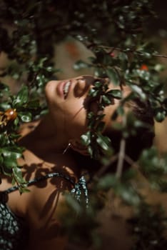 In the closeup shot, a woman is surrounded by foliage, evoking tranquility and deep connection with nature
