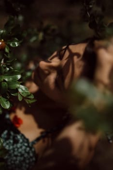 The photo features a serene woman surrounded by green foliage, creating a moody and intimate atmosphere in nature
