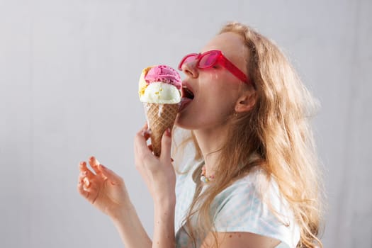 girl eats ice cream balls in hot summer, escape from the girl in pink glasses eats ice cream balls in the hot summer, escape from the heat