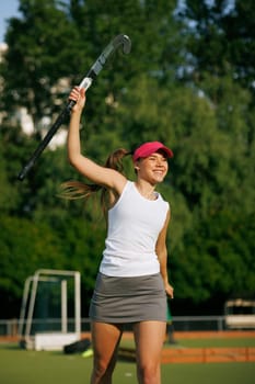 girl hockey player plays field hockey on a sunny day, female hockey player celebrates a goal scored, victory in a field hockey match, active sport for girls