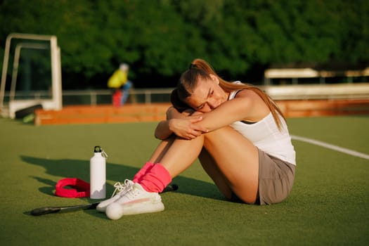 girl hockey player plays field hockey on a sunny day, hockey player upset after losing a match, active sport for girls