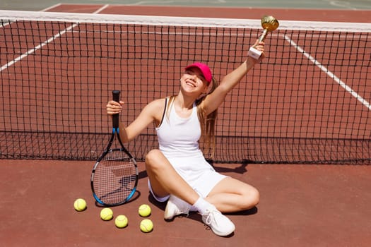 Excited young female tennis player celebrating victory on the card, tennis cup, victory in tennis, big tennis concept
