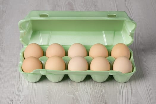 Farm egg chicken egg in green packaging horizontal gray background.