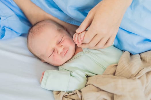 A baby lies with the mother after childbirth, resting peacefully. The serene moment captures the bond between mother and child as they begin their journey together. The hospital environment ensures a safe and comforting space for this intimate interaction.