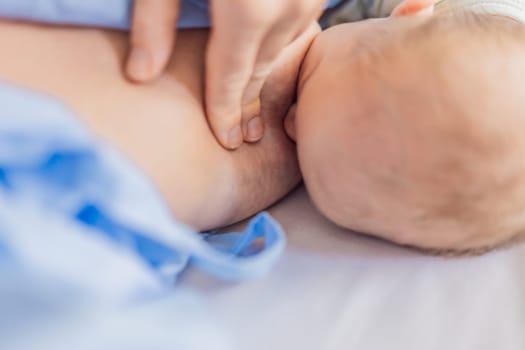 A mom breastfeeds her newborn baby in the hospital. The intimate moment fosters bonding between mother and child, promoting emotional connection and providing essential nourishment for the baby's well-being.