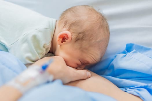 A mom breastfeeds her newborn baby in the hospital. The intimate moment fosters bonding between mother and child, promoting emotional connection and providing essential nourishment for the baby's well-being.