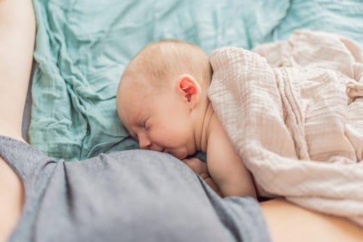 Newborn baby sleeps peacefully with mom at home, showcasing the close bond between mother and child in a comforting family setting.