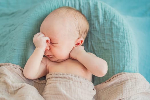 The baby is sleeping peacefully in his cozy nest. Newborn photo session captures the serene innocence and warmth of early moments.