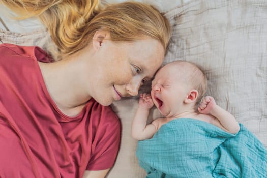 Mom with newborn baby relaxing on the sofa at home. This tender moment highlights the bond between mother and child in a comfortable and loving family environment.