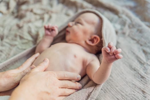 The newborn's skin is peeling. Mom uses skin products and massages to care for and soothe the baby's delicate skin, ensuring comfort and promoting healthy skin.
