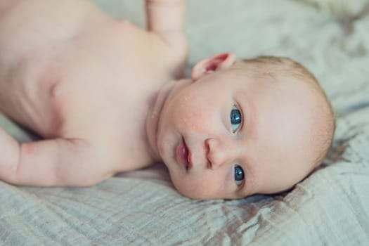 The newborn's skin is peeling. Mom uses skin products and massages to care for and soothe the baby's delicate skin, ensuring comfort and promoting healthy skin.