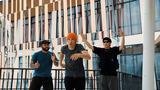 Hip hop team dance break dance while multicultural friend surrounded and clapping hands to cheer or encourage his friend to dance. Active and energetic street dance. Outdoor sport 2024. Endeavor.