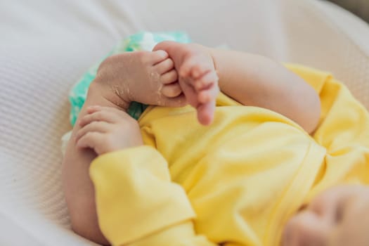 The newborn's skin is peeling. Mom uses skin products and massages to care for and soothe the baby's delicate skin, ensuring comfort and promoting healthy skin.