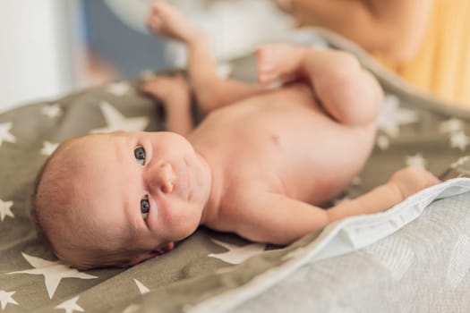 The newborn's skin is peeling. Mom uses skin products and massages to care for and soothe the baby's delicate skin, ensuring comfort and promoting healthy skin.