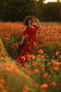 Woman poppy field red dress hat. Happy woman in a long red dress in a beautiful large poppy field. Blond stands with her back posing on a large field of red poppies