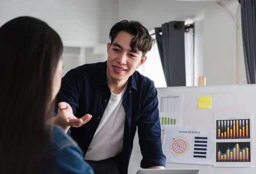 A group of business people actively discussing and exchanging opinions in a contemporary office environment, fostering teamwork and collaboration.