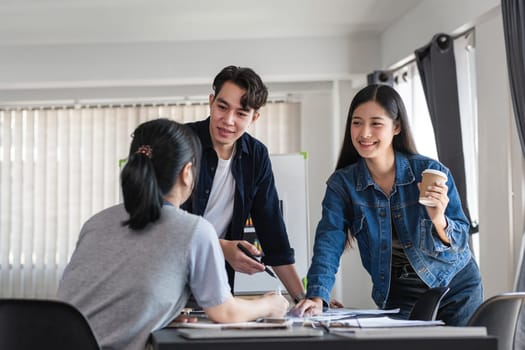 A group of business people exchanging ideas and opinions in a contemporary office environment, fostering teamwork and collaboration.