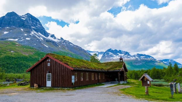 A cozy wooden cabin with a grass roof nestled in a stunning mountain landscape in Norway. Innerdalen Norway's most beautiful mountain valley