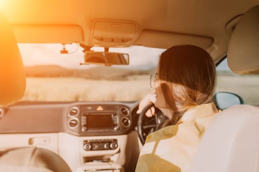 Relaxed business woman talking on video call on phone in automobile. Rested female professional saying bye on video chat in business car. Beautiful lady making video message in luxury car.