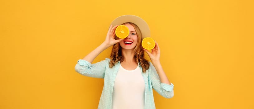 Summer portrait of happy joyful young woman with fresh slices of fresh orange fruits, cheerful girl smiles posing on bright yellow background