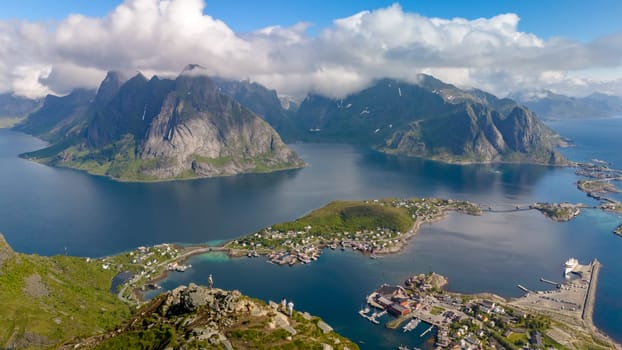 Aerial view of Reine village on Lofoten Islands, Norway showcases stunning beauty - mountains, fjords, and quaint houses. Reinebringen Lofoten Norway