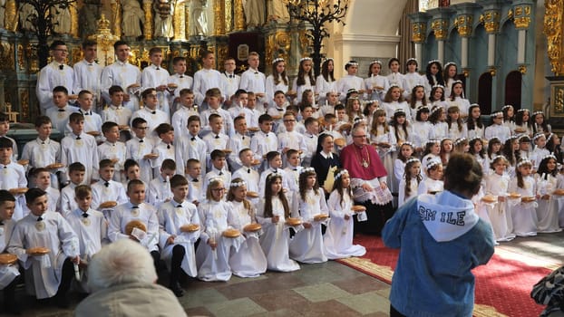 30.05.23 Vinnitsa, Ukraine: the holiday of the first communion and solemn liturgy in the Catholic church where many children receive their first communion