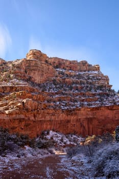 Beautiful winter landscape of the Grand Wash in Capitol Reef, Utah. Snow-dusted red rock canyon walls under a clear blue sky, offering a stunning natural scenery and peaceful atmosphere - USA